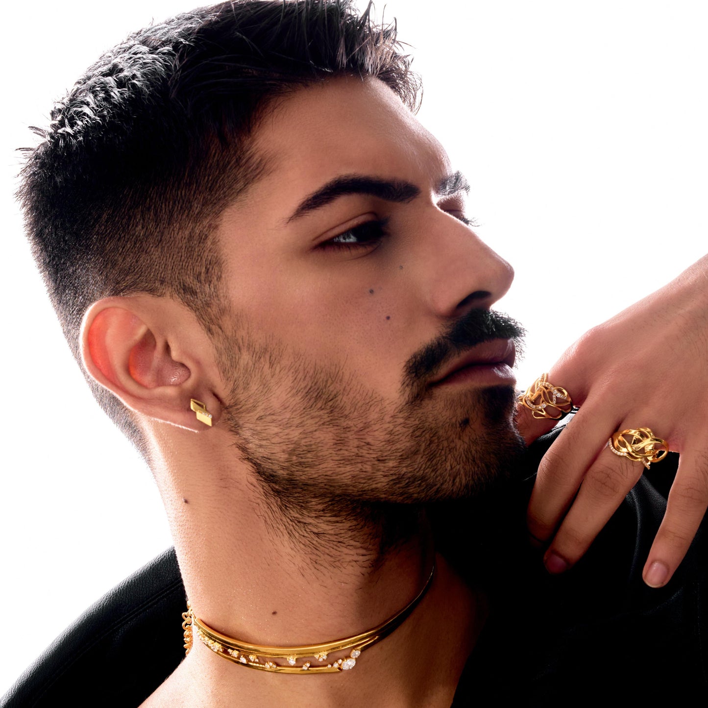 Man with gold jewelry on a white background