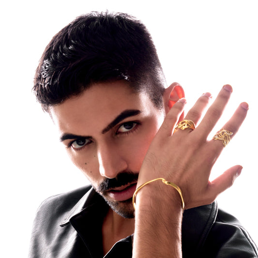 Man wearing gold jewelry on a white background