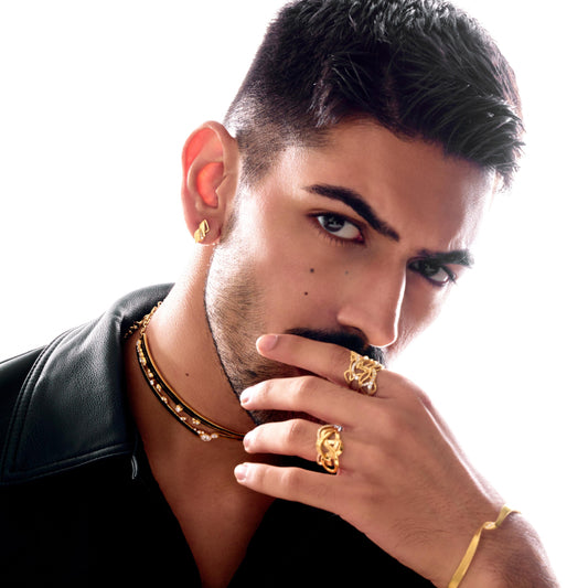 Man wearing gold jewelry with a white background
